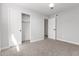 This bedroom features a neutral color scheme, carpet, and a closet space for storage at 1839 E Indigo St, Mesa, AZ 85203