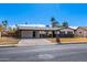 Charming single-story home with a well-maintained yard, covered parking and gray color scheme at 1839 E Indigo St, Mesa, AZ 85203