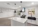 Open concept kitchen with center island, black sink, white cabinets, and modern lighting at 1839 E Indigo St, Mesa, AZ 85203