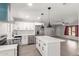 Modern kitchen featuring stainless steel appliances, white cabinets, an island, and ample countertop space at 1839 E Indigo St, Mesa, AZ 85203