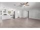 Open-concept living space with modern flooring, leading into the kitchen with white cabinets at 1839 E Indigo St, Mesa, AZ 85203