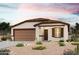 Single-story home with 2-car garage, desert landscaping, and a tiled roof at 1875 Broken Arrow Dr, Wickenburg, AZ 85390