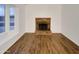 Living room with a brick fireplace and hardwood floors at 19002 N 47Th Dr, Glendale, AZ 85308