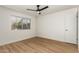 Well-lit bedroom with light wood floors and ceiling fan at 19819 N 6Th Dr, Phoenix, AZ 85027