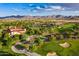 Aerial view of community with clubhouse, golf course, and mountain views at 20359 N 262Nd Dr, Buckeye, AZ 85396