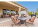 Relaxing backyard patio with fire pit, seating, and grill at 20359 N 262Nd Dr, Buckeye, AZ 85396