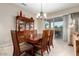 Bright dining room featuring a wooden table and built-in hutch at 20359 N 262Nd Dr, Buckeye, AZ 85396