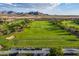 Golf course with mountain backdrop and golf carts at 20359 N 262Nd Dr, Buckeye, AZ 85396