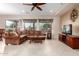 Spacious living room with a brown sectional sofa and a ceiling fan at 20359 N 262Nd Dr, Buckeye, AZ 85396