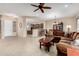 Spacious living room with a brown sectional sofa and kitchen view at 20359 N 262Nd Dr, Buckeye, AZ 85396