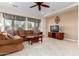 Spacious living room with a brown sectional sofa and a ceiling fan at 20359 N 262Nd Dr, Buckeye, AZ 85396