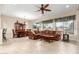 Spacious living room with a brown sectional sofa and a ceiling fan at 20359 N 262Nd Dr, Buckeye, AZ 85396