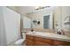 Clean bathroom with tub, vanity, and wood cabinets at 211 E Desert Wind Dr, Phoenix, AZ 85048