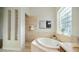 Spa-like bathroom with soaking tub and glass block window at 211 E Desert Wind Dr, Phoenix, AZ 85048