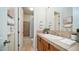 Bathroom with tiled shower, vanity, and wood cabinets at 211 E Desert Wind Dr, Phoenix, AZ 85048