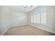 Spacious bedroom featuring carpet and plantation shutters at 211 E Desert Wind Dr, Phoenix, AZ 85048