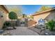 A stone pathway leads to an iron gate, with a tiled fountain as a focal point at 211 E Desert Wind Dr, Phoenix, AZ 85048