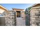 Ornate iron gate opens to a brick-paved pathway, leading to the home's entrance at 211 E Desert Wind Dr, Phoenix, AZ 85048