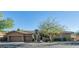 This single-story home features a two-car garage and desert landscaping at 211 E Desert Wind Dr, Phoenix, AZ 85048