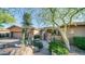 Desert landscaping accents this single-story home's stucco exterior, highlighting a charming entrance at 211 E Desert Wind Dr, Phoenix, AZ 85048