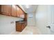 Laundry room with wood cabinets and tile flooring at 211 E Desert Wind Dr, Phoenix, AZ 85048