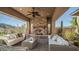 Relaxing patio with wicker furniture and a stone fireplace at 211 E Desert Wind Dr, Phoenix, AZ 85048