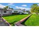 Green backyard with mature trees and lawn at 2130 E San Juan Ave, Phoenix, AZ 85016