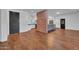 Modern kitchen with white cabinets, gray island, and exposed brick at 2130 E San Juan Ave, Phoenix, AZ 85016