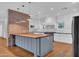 Bright kitchen with white cabinets, butcher block island, and brick accent wall at 2130 E San Juan Ave, Phoenix, AZ 85016