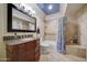 Updated bathroom with granite vanity, tiled shower, and decorative shower curtain at 2131 W Ironwood Dr, Chandler, AZ 85224