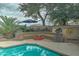 Inviting pool area with fire pit, seating, and lush landscaping at 2131 W Ironwood Dr, Chandler, AZ 85224