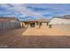 Backyard view of home with desert landscaping at 21411 W Meadowbrook Ave, Buckeye, AZ 85396