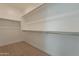 Large walk-in closet with double hanging rods and shelving at 21411 W Meadowbrook Ave, Buckeye, AZ 85396