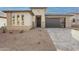 Modern single-story house with stone accents and a gray garage door at 21411 W Meadowbrook Ave, Buckeye, AZ 85396