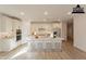 Modern kitchen with white cabinets, an island, and hardwood floors at 21411 W Meadowbrook Ave, Buckeye, AZ 85396