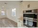 Modern kitchen features stainless steel appliances and light-toned cabinetry at 21411 W Meadowbrook Ave, Buckeye, AZ 85396