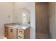 Modern bathroom with gray countertop, wood cabinets and walk-in shower at 21418 W Meadowbrook Ave, Buckeye, AZ 85396