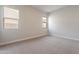 Well-lit bedroom featuring neutral walls and carpet at 21418 W Meadowbrook Ave, Buckeye, AZ 85396