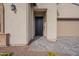 Front entry with a black door and a stone walkway at 21418 W Meadowbrook Ave, Buckeye, AZ 85396