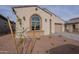 House exterior showcasing a large window and a small tree in front at 21418 W Meadowbrook Ave, Buckeye, AZ 85396