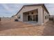 Back exterior view of house showcasing patio and backyard at 21418 W Meadowbrook Ave, Buckeye, AZ 85396