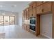 Kitchen with wall ovens, gas cooktop and custom cabinetry at 21418 W Meadowbrook Ave, Buckeye, AZ 85396