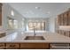 Kitchen island with white countertop and sink overlooking Gathering room at 21418 W Meadowbrook Ave, Buckeye, AZ 85396