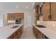 Spacious kitchen island with white quartz countertop and stainless steel sink at 21418 W Meadowbrook Ave, Buckeye, AZ 85396