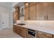 Modern kitchen with light wood cabinets, quartz countertops, and stainless steel appliances at 21418 W Meadowbrook Ave, Buckeye, AZ 85396