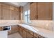 Modern kitchen with light wood cabinets and white quartz countertops at 21418 W Meadowbrook Ave, Buckeye, AZ 85396