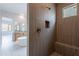 Large walk-in shower with wood-look tile and built-in seat at 21418 W Meadowbrook Ave, Buckeye, AZ 85396