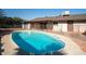 Inviting kidney-shaped pool with ample deck space at 2215 E Des Moines Cir, Mesa, AZ 85213