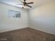 Spacious bedroom with ceiling fan and neutral carpet at 2215 E Des Moines Cir, Mesa, AZ 85213