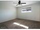 Bright bedroom with ceiling fan and neutral carpet at 2215 E Des Moines Cir, Mesa, AZ 85213